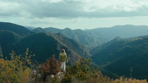 Cinematic Woman in Traditional Sweater in Mountain