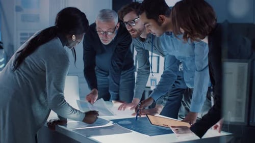 Diverse Team Collaborating on Project in Modern Office