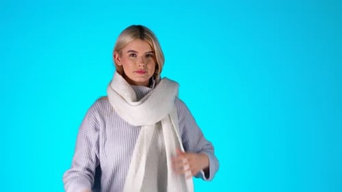 Woman with Blonde Hair in Scarf on Blue Background