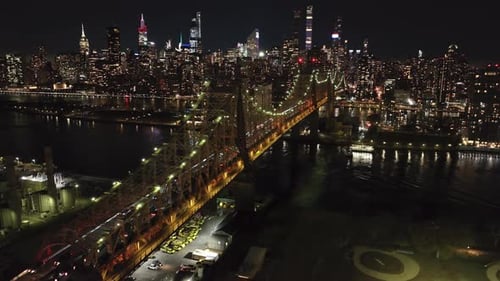Night Aerial View of the Illuminated Queensboro Bridge Connecting Manhattan and Queens Over East