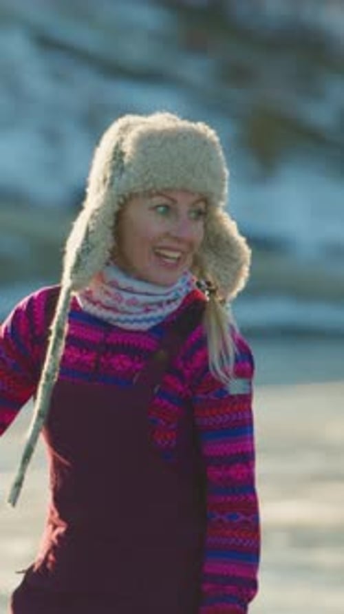 Joyful Skater in Vibrant Winter Attire with a Furry Hat Gliding on Ice Embracing the Chill of the