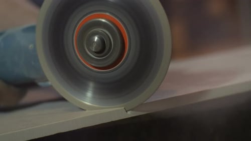 Closeup Circular Saw Makes Gap in Ceramic Tile
