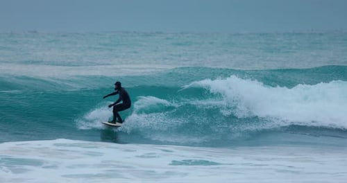 Surfer in Wetsuit Ride on Wave in Ocean Winter Surfing on Perfect Waves