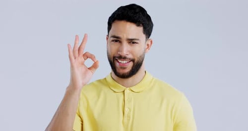 Ok hands, face and man in studio for vote, good review and trust on white background
