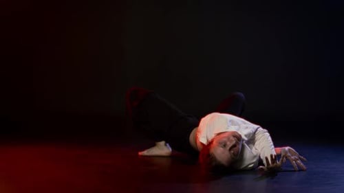 Agile Woman Performing Unique Contortion Dance in Studio