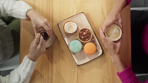 Closeup of Female Hands Holding Coffee in a Cafe