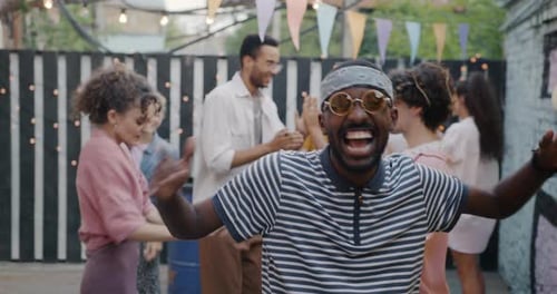 Portrait of Sad African American Man Standing Then Dancing Having Fun at Open Air Party in Cafe