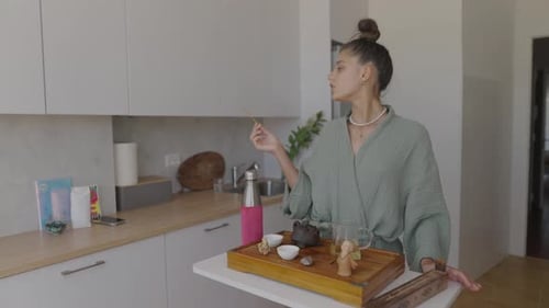 Woman preparing tea in kitchen