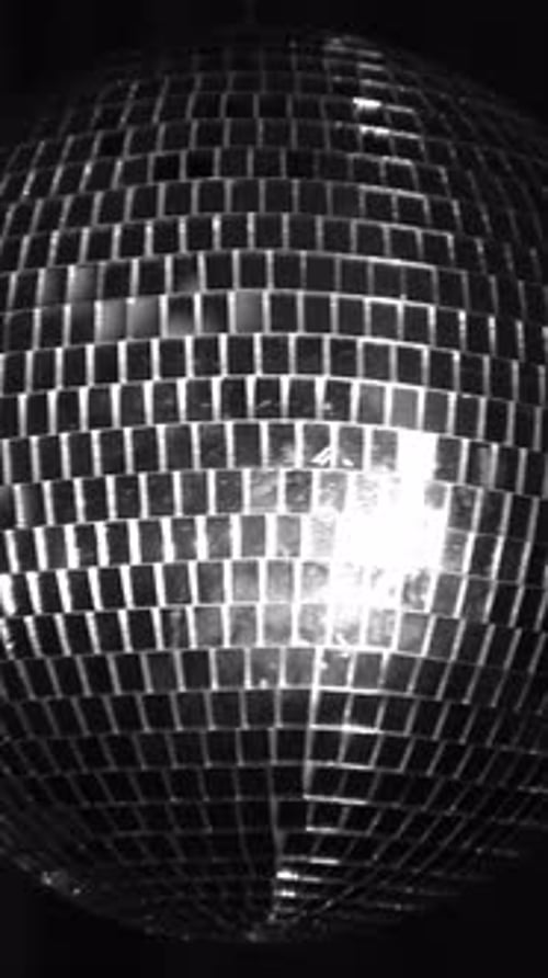 Bright disco ball reflecting lights. Vertical