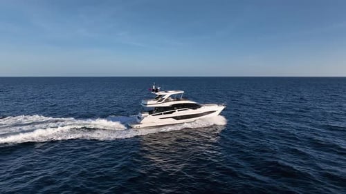 Luxury yacht driving at sea with empty horizon in the background
