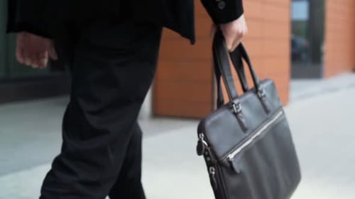 One Serious Manager Lawyer Hold Case with Documents and Walk
