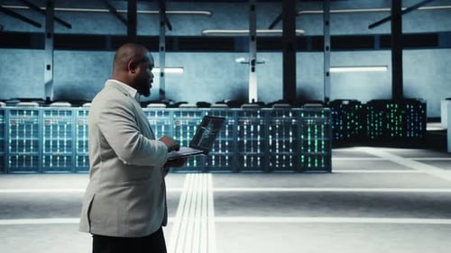 Server Room System Administrator Using Laptop to Do AI Automatization