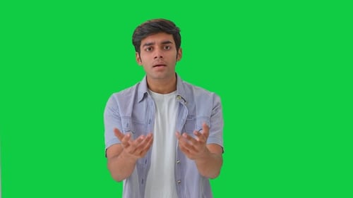 Confused Indian boy asking questions Green screen