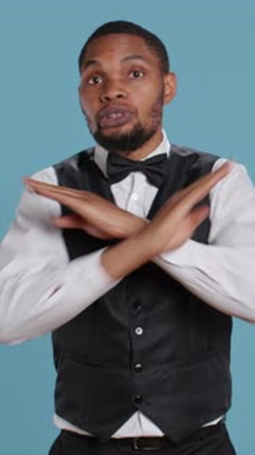 Vertical Video Irritated Hotel Concierge Staff Expressing Stop Sign and Showing His Disapproval