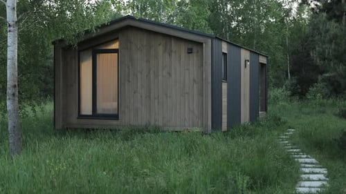 Wooden Scandinavian House the Light is on in the Window Forest Cabin in the Middle of a Forest in