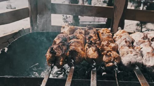 Grilling Shashlik on Barbecue Grill Outdoors Prepare Shish Kebab on Skewer BBQ