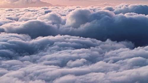 Golden sunlight shimmers over a vast ocean of clouds from Hawaii highlands
