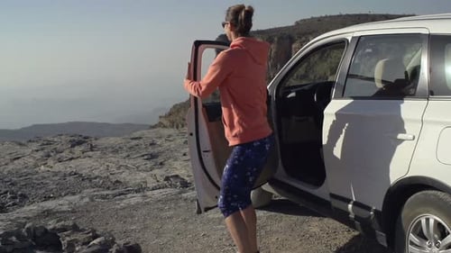 Young Woman Walking Out of Car and Admire Canyon View, Super Slow
