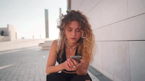 Woman Using Smartphone in Urban Environment