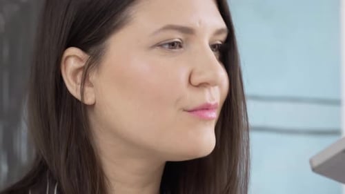 Young women posing while doing make up in the bedroom, close up