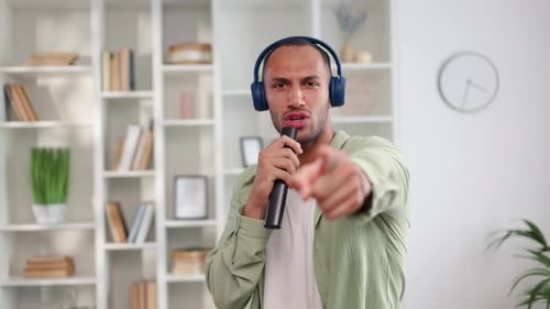 Casually Dressed Energetic Male Adult Dancing at Drive Music at Home