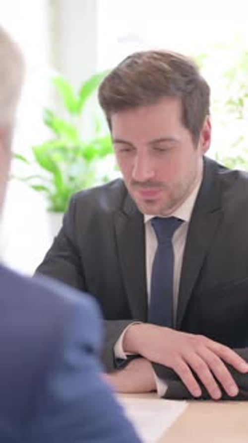 Businessman in Suit Meeting with Client Indoors
