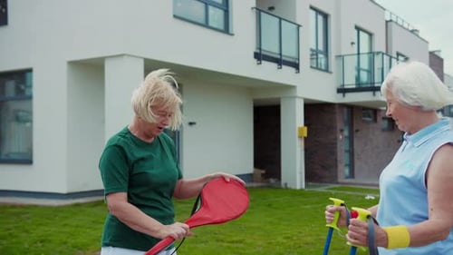 Senior Women Chatting and Exercising Outdoors