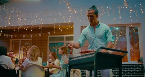 Handsome Mixed Race Man Cooking Barbecue and Grill in BBQ Party in Backyard Prores