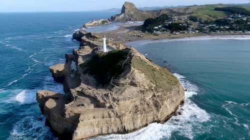 Lighthouse at Castlepoint in New Zealand - Rotating Aerial Drone View