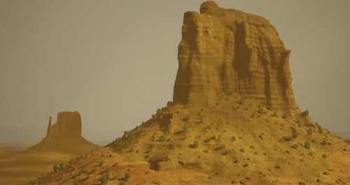 Majestic Rock Formations Rise Above the Desert Landscape During Golden Hour