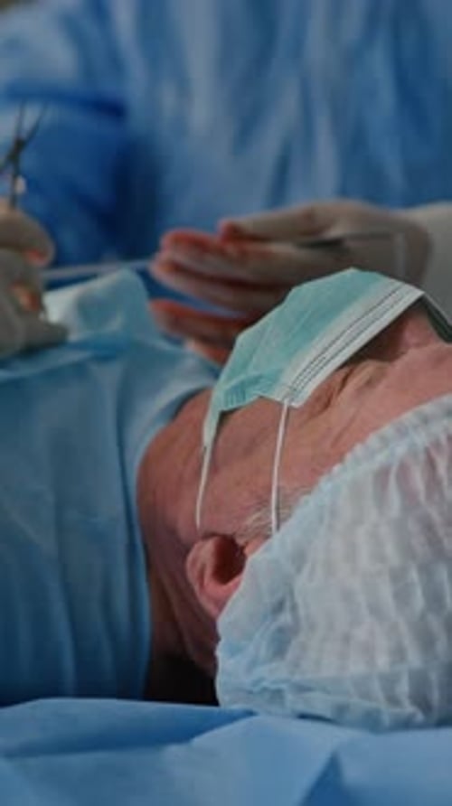 Two Unrecognizable Surgeons Operating on Patient