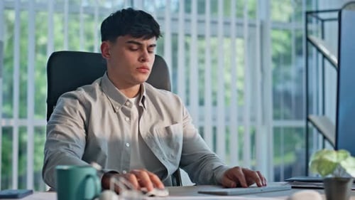 Frowning Guy Texting Pc Keyboard Working Computer in Open Space Office Closeup