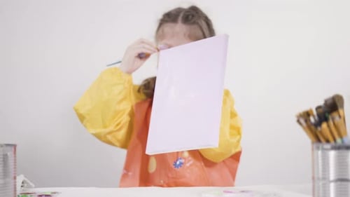 Little Girl Painting with Acrylic Paint on Canvas with Her Mother for a Distant Learning Art Project