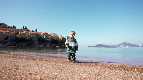 Toddler Strolls on Pebble Beach