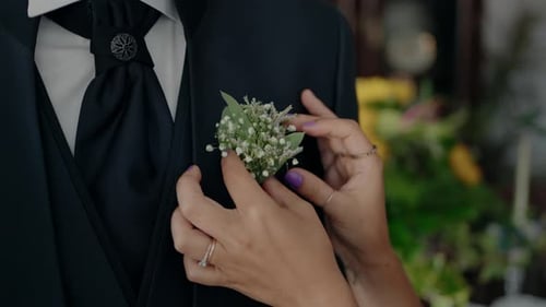 Woman Attaching Boutonniere to a Man's Suit