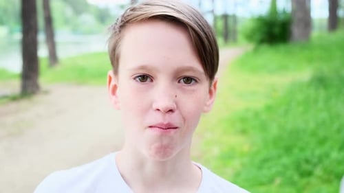 Handsome guy is chewing snack in park