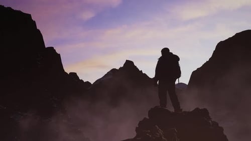 Adventure Man on Top of Rocky Mountain Landscape