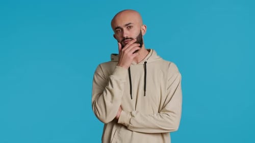 Man Thinking with Hand on Chin on Blue