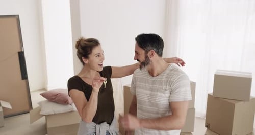 Happy Couple Holding Keys in New Home