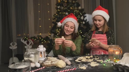 Girls Baking Christmas Cookies at Home