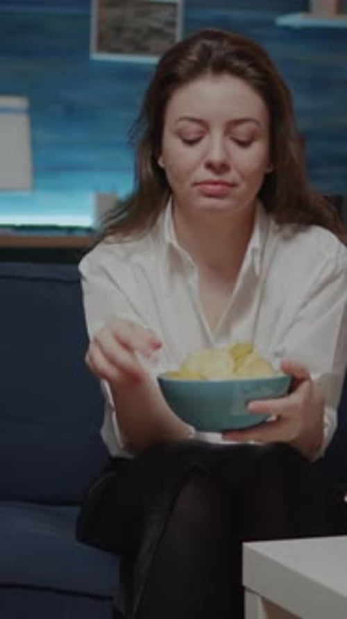 Vertical Video Portrait of Caucasian Woman Eating Chips From Bowl