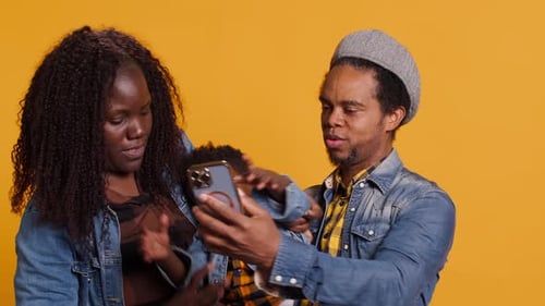 Family Poses for Phone Photo in Studio