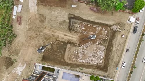 Heavy Machinery at Work Aerial View of Soil Unloading at Construction Site