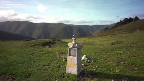 Camino de Santiago yellow arrow shell sign showing way to Compostela