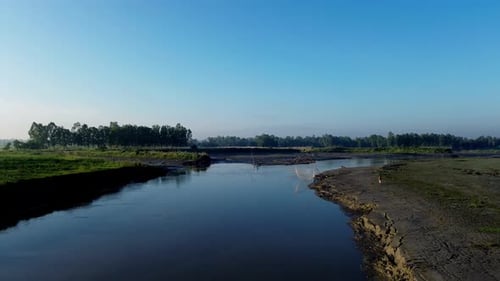 "Unobstructed Tranquility: Clear Blue Sky Meets Serene River"