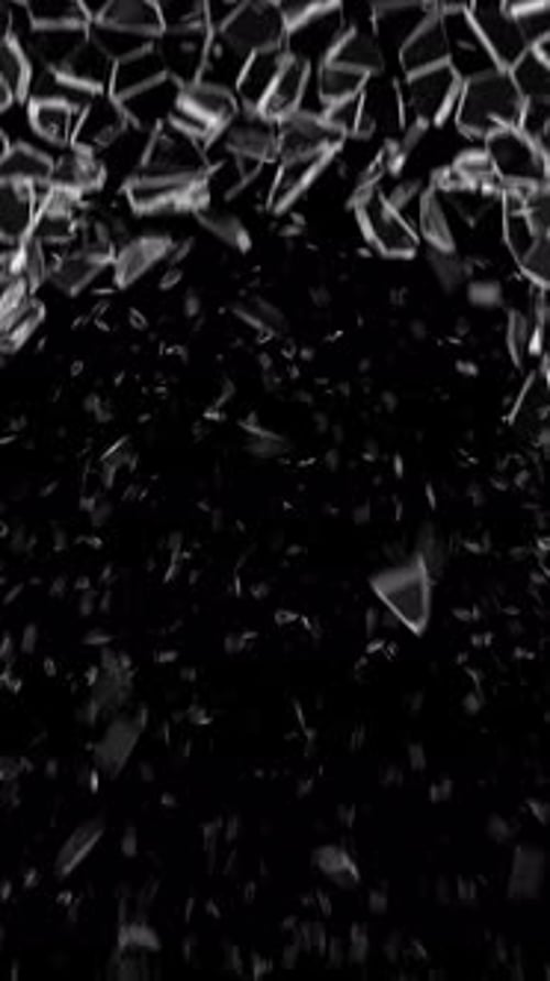 Glass breaking. Flying glass shards. Broken glass on a black background. Broken glass shard.