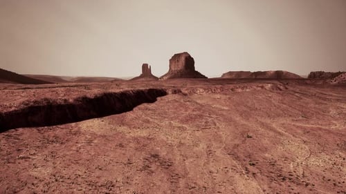Desert Landscape With Distant Rock Formation