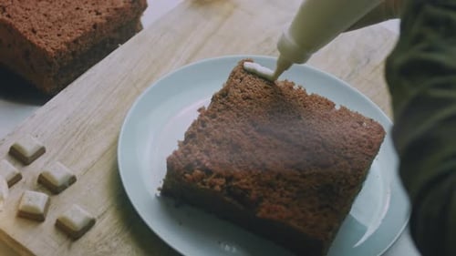 Icing Being Applied to a Chocolate Cake