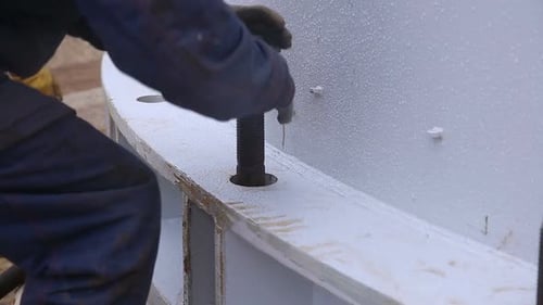 Worker Tightening Bolt on Heavy Equipment