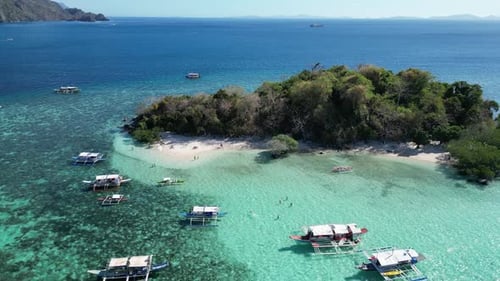 Drone Reveal Tour Boats in Clear Blue Water of Tropical CYC Island Reef in Coron